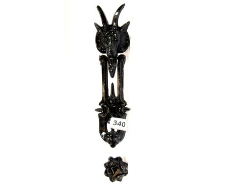 A cast iron goats head door knocker, H. 26cm.