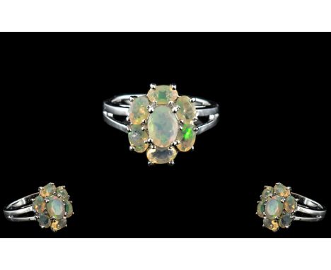 Opal Seven Stone Cluster Ring, size N, six oval cut, facetted opals surrounding a further, slightly larger one, forming a sty