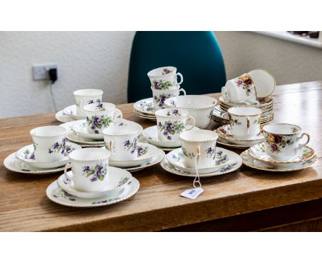 Radfordian Tea Service, comprising seven trios of cup, saucer and side plates, a large cake plate and a sugar bowl with two s