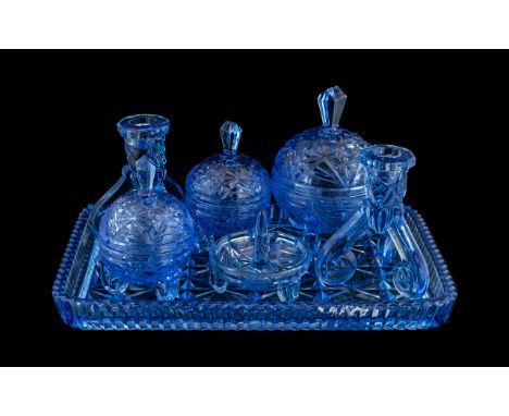 Blue Glass Dressing Table Set, comprising a glass tray, pair of candlesticks, three lidded trinket bowls and a ring holder.