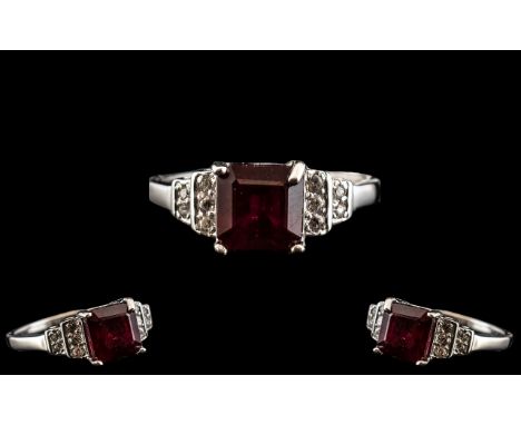 Ruby and Zircon Ring, a square cut, 2.5ct ruby solitaire set to the centre, flanked by round cuts of natural white zircons, o