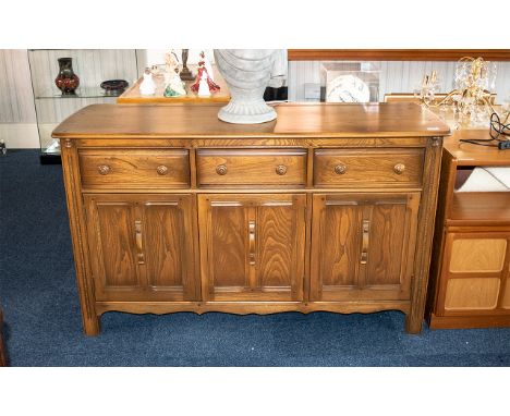 Ercol Dresser of Typical Style with three frieze drawers above cupboard space, 34 inches (app.85cms) high x 57 inches (app.14