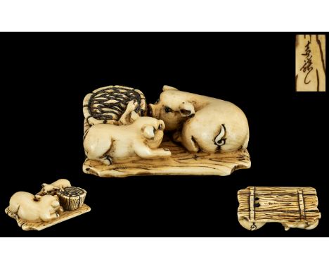 Japanese Meiji Period Carved Ivory Netsuke of unusual form depicting a sow with her piglet sitting on boards, the pig's eyes 