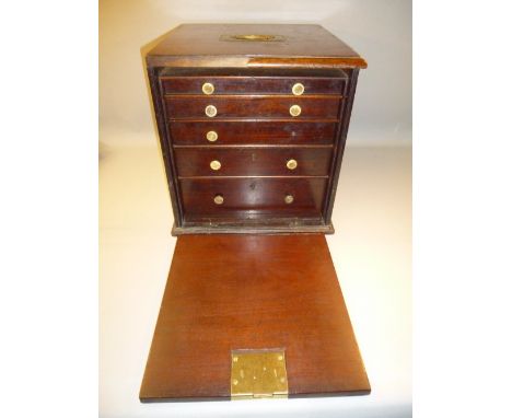 WATCHMAKER'S MAHOGANY CABINET WITH A FALL FRONT DISCLOSING FIVE GRADUATED DRAWERS CONTAINING 23 GEORGIAN AND LATER WATCH MOVE