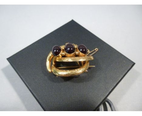 VICTORIAN YELLOW METAL BROOCH WITH THREE RUBY COLOURED GLASS CABOUCHONS (10.7g GROSS) TOGETHER WITH ANOTHER VICTORIAN YELLOW 