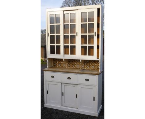 EDWARDIAN PAINTED PINE DRESSER WITH THREE SLIDING GLAZED PANELLED DOORS ABOVE, SHELF, THREE DRAWERS AND THREE SLIDING DOORS B