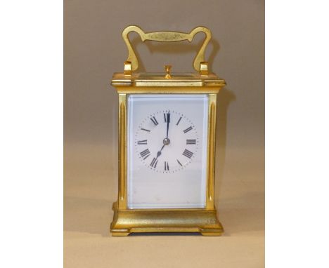 FRENCH CARRIAGE CLOCK WITH A WHITE ENAMELLED DIAL ENCLOSING AN EIGHT-DAY REPEATING MOVEMENT STRIKING ON A COILED GONG IN A GI