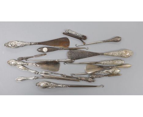 Four repousse silver handled shoe horns, seven similar button hooks, three nail implements, a pair glove stretchers and small