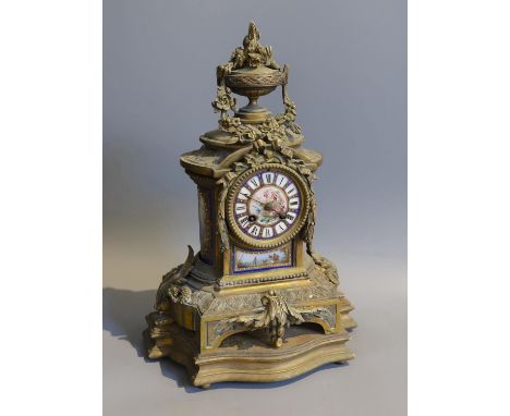 A 19th century French gilt metal and porcelain eight day mantel clock, with floral urn pediment, height 42cm