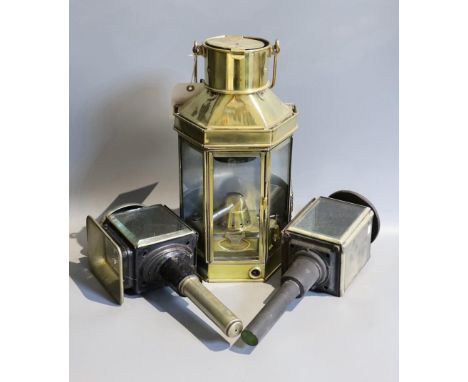 A Victorian brass carriage lamp, with turned wood handle, height 41cm, together with two other carriage lamps