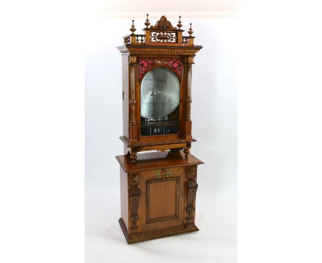 A 19th century oak and walnut cased coin operated Polyphon disc music player retailed by Nicole Freres Leipzig, the double ve