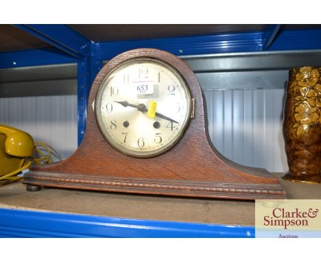 An oak cased two hole mantel clock