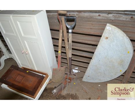 A pick axe; spade; fork etc. 