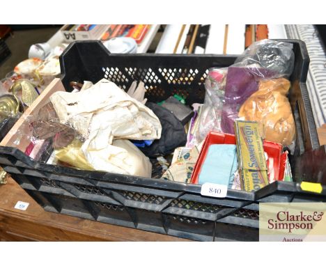 A box containing various vintage clothing etc