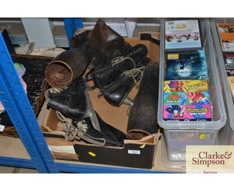 A box containing vintage ice skates and a pair of buskins