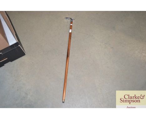 A walking stick the handle in the form of a jaguar car mascot