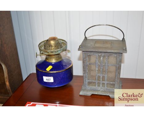 A blue and gilt oil lamp font; and a solar powered lantern
