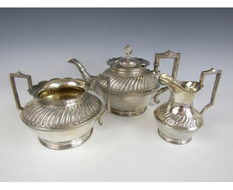 A Victorian three piece electroplate tea service, comprising tea pot, two handled sugar bowl and milk jug, each with gadroone