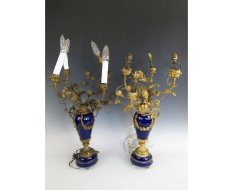 A pair of Sevres style porcelain and gilt metal electric table lamps, each modelled as a slender ormolu-mounted cobalt blue o