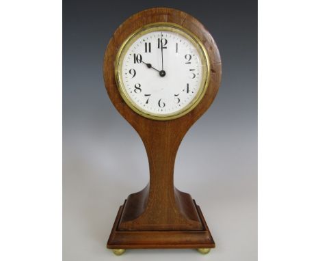 An Edwardian balloon mantel clock, with white enamelled face and Arabic numerals, in a mahogany case with inlaid decoration, 