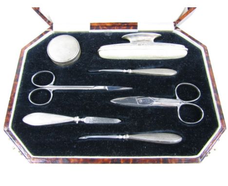A cased George VI silver manicure set, with engine turned decoration, Birmingham, 1937