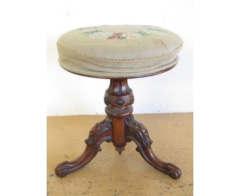 A Victorian upholstered mahogany adjustable tripod piano stool