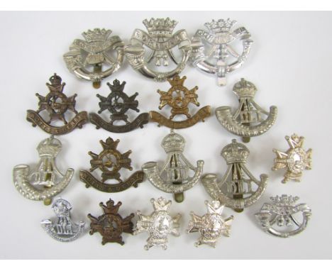 A quantity of Durham Light Infantry, Duke of Cornwall's Light Infantry and Notts & Derby Regiment metal insignia