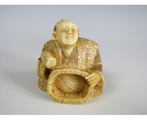 A signed Meiji Japanese ivory netsuke modelled as a cooper