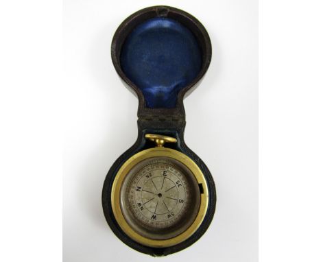 A late 19th Century combination pocket aneroid barometer and magnetic compass, of double-faced drum form in gilt metal, with 