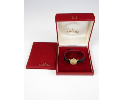 A lady's Omega gold plated wrist watch, having manual wind movement and circular face with baton markers, in original case wi