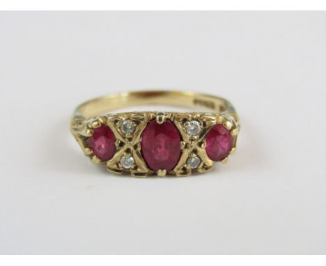 A ruby and diamond dress ring, with three subtly graded oval stones interspersed by saltire set diamond brilliants, the centr