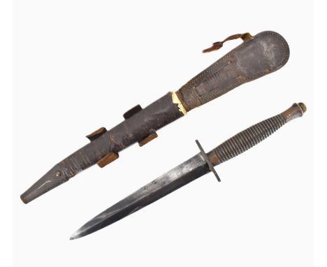 A WWII third pattern Fairbairn Sykes fighting knife, unmarked, with brass ribbed handle, double-edged blade, length 17cm, ove