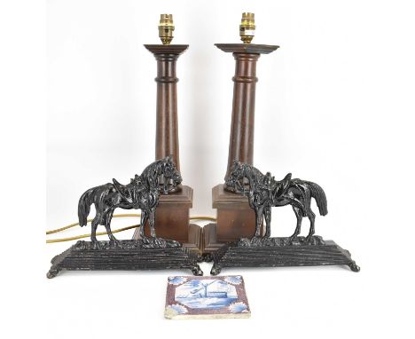 A pair of 19th century cast iron horse doorstops, later painted black, 21 x 28cm, a pair of turned oak candlesticks on square