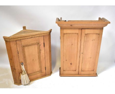 A pine corner wall-hanging cupboard with fielded and panelled door, 86 x 72 x 42cm, together with a pine wall-hanging cupboar