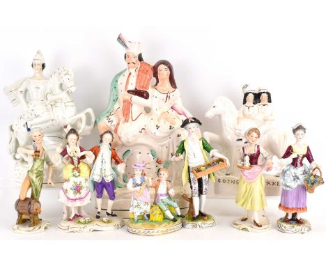 Three 19th century Victorian flatback figures, one a courting couple above a clock face, height 38cm, one George and Dragon a