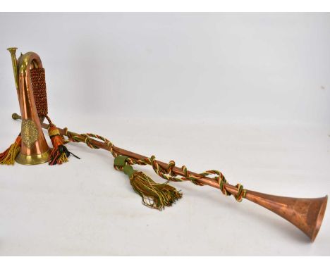 A copper and brass bugle with emblem for Argyll and Sutherland with twisted rope to handle, length 28cm, together with a copp