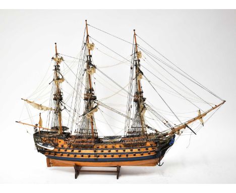 A scale model of HMS Victory, on stand, with rigging, height 77cm, length 104cm.