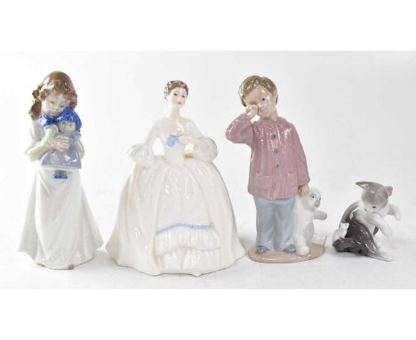 A Royal Doulton figure HN3222 'Kelly', height 19.5cm, a Nao figure of a girl holding a doll, a Nao figure of a boy holding a 