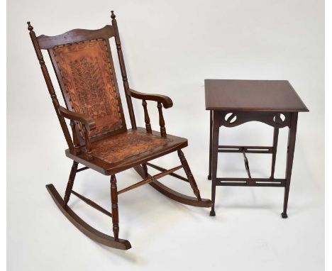 † An American red walnut rocking chair upholstered with tooled leather and studded back and seat, together with an early 20th