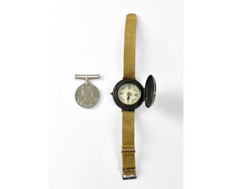 A military wrist compass on a webbing strap and a WWII War Medal (2).Condition Report: - The compass extremely worn, with los