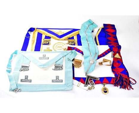 A group of Masonic regalia, comprising three aprons, one inscribed 'East Lancashire Asst', three sashes, one set with a jewel