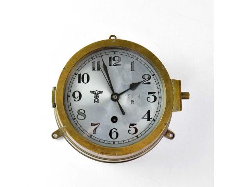 A WWII German Kriegsmarine U-Boat brass cased bulkhead clock, the 16cm silvered dial set with Arabic numerals within minute m
