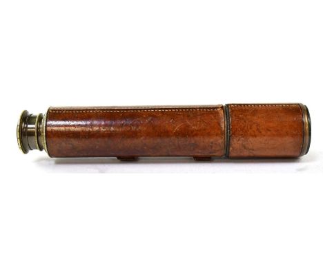 BROADHURST CLARKSON &amp; CO; an early 20th century leather bound brass four-drawer telescope with sun shade and eyepiece cov