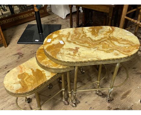 A nest of three vintage onyx tables on castors, shipping unavailable