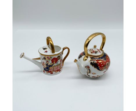 A Royal Crown Derby porcelain miniature set featuring a teapot and watering can in the classic Imari pattern. Featuring deep 