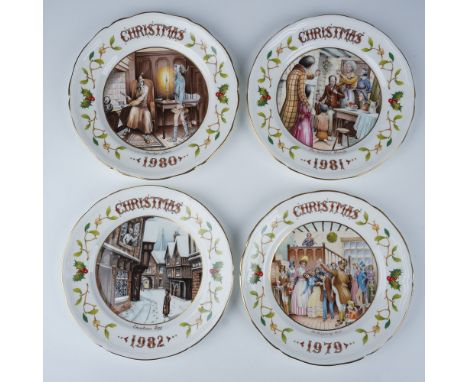 Aynsley English fine bone china Christmas plate collection featuring four plates from the years 1979, 1980, 1981, and 1982. E