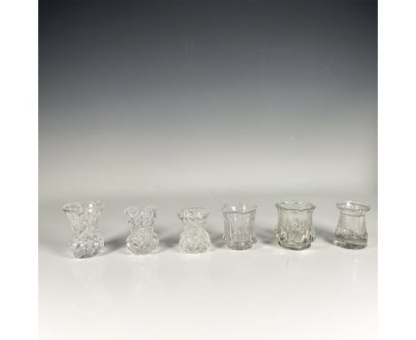 Set of six clear glass holders, featuring a slender shape and intricate glass cut designs. Dimensions of the largest item: 3"