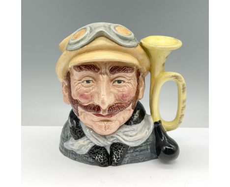 This lot features a Royal Doulton character jug titled "Veteran Motorist" (D6633), made in England. The jug depicts a finely 