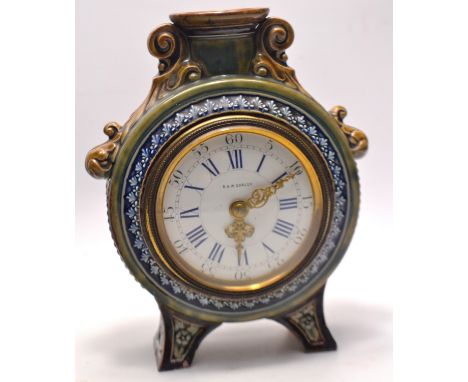 A beautiful example of a Victorian Doulton Lambeth moon shaped mantel clock,by Ada Worthy 1883, with relief scroll mounts, 3.
