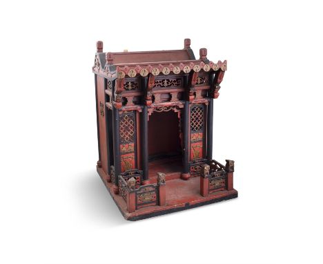A CHINESE RED LACQUER PAGODA SHRINE 19TH CENTURY  of traditional shape with double arched roof, and fitted with pierced honey